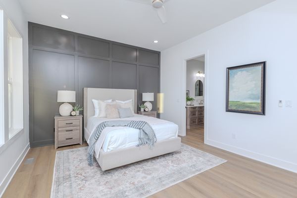Primary bedroom with paneled accent wall