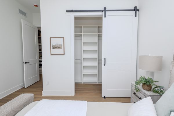 Bedroom with barn-door closet