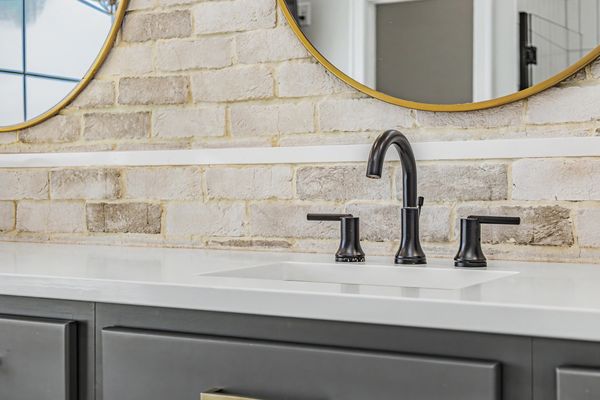 Primary vanity with brick accent wall